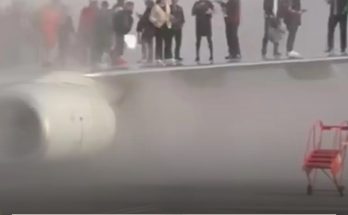 American Airlines plane erupts into flames forcing passengers onto aircraft wing